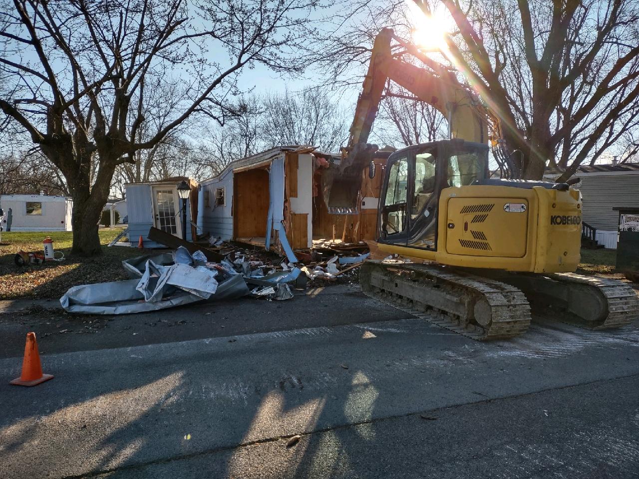 Hill Demolition excavator removing an old mobile home